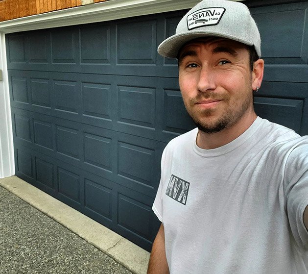 man in front of painted garage door